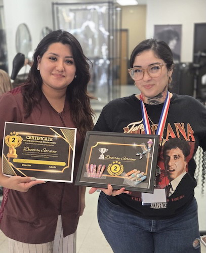 Two students holding nail battle certificates