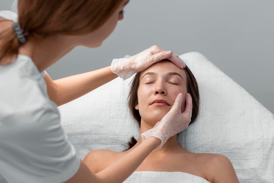 Woman receiving a skin assessment from a Cosmetologist. Learn more about beauty schools in San Antonio.