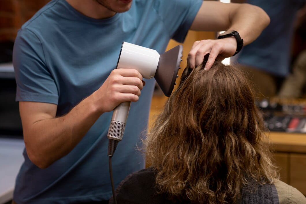 Cosmetology Operator blow drying a client's hair