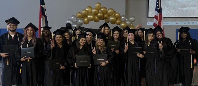 graduates Gradutes of Nuvani Institute posing in their graduation gowns with their diplomas